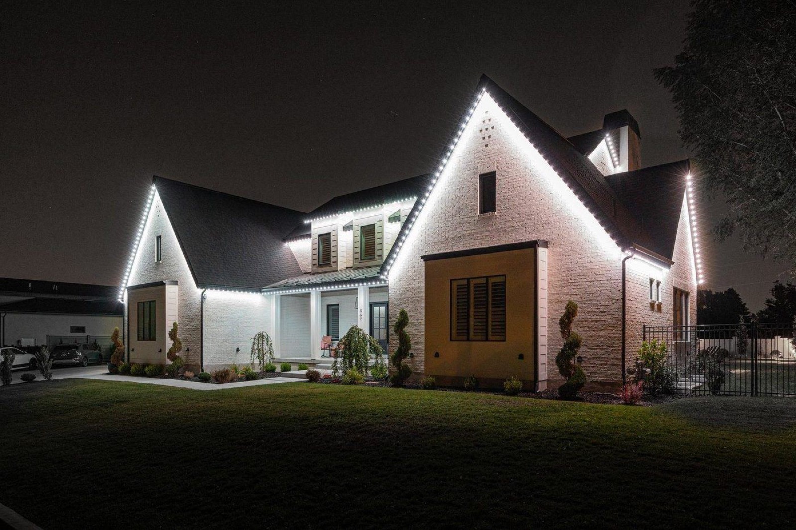 White brick home with a crisp white roofline run picking out every gable